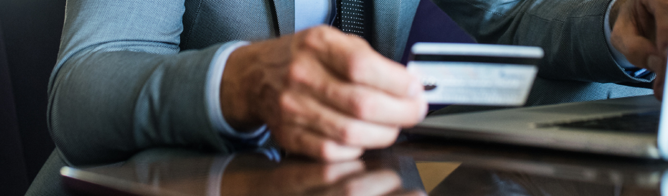 Man using credit/debit card on laptop